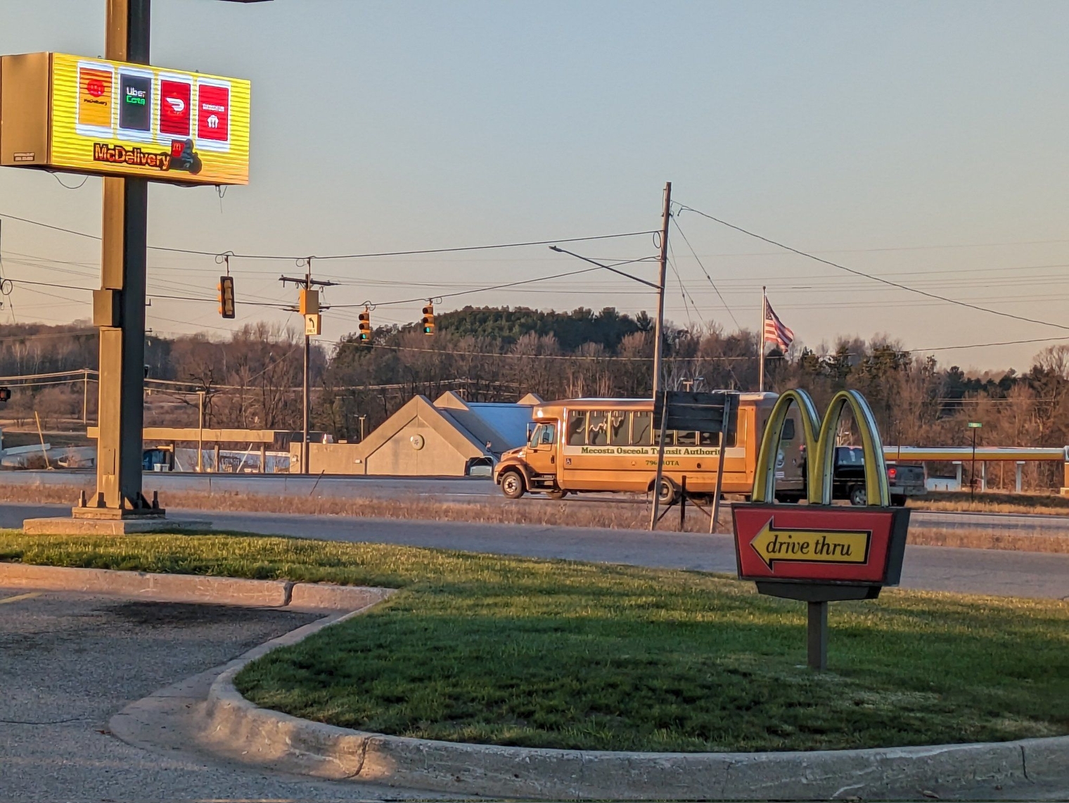 A Mecosta Osceola Transit Authority minibus passing by on the street