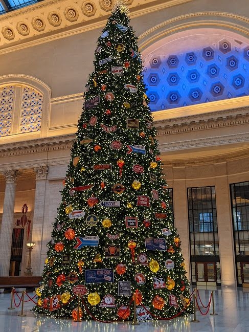 The holiday tree inside Union Station, decorated with railroad logo ornaments