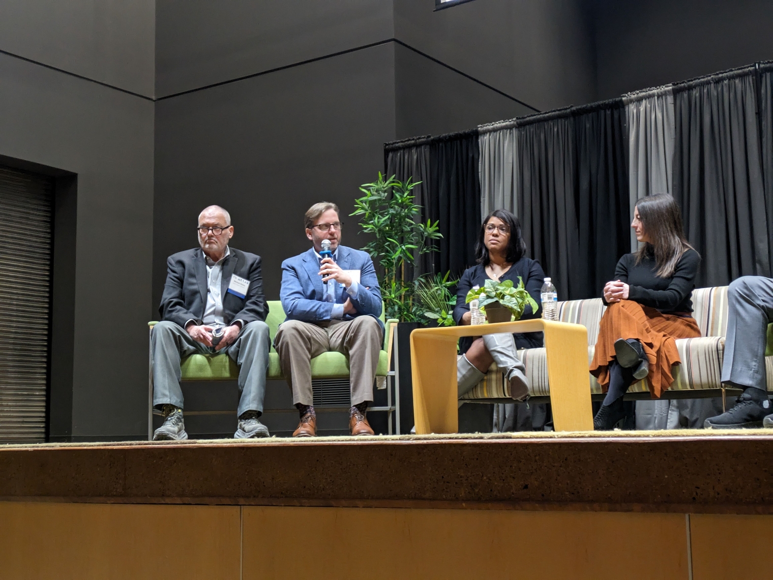 The panelists onstage addressing the audience