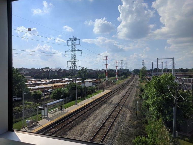 The platform as seen from above, framed by high voltage power lines running along both sides of the tracks.