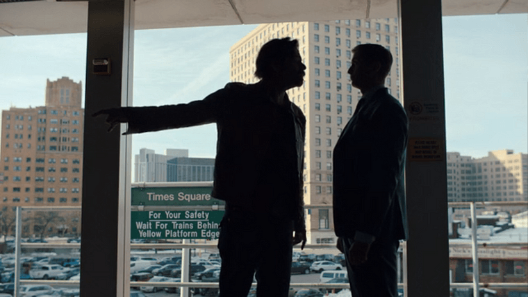 Two silhouetted characters standing on the Times Square platform