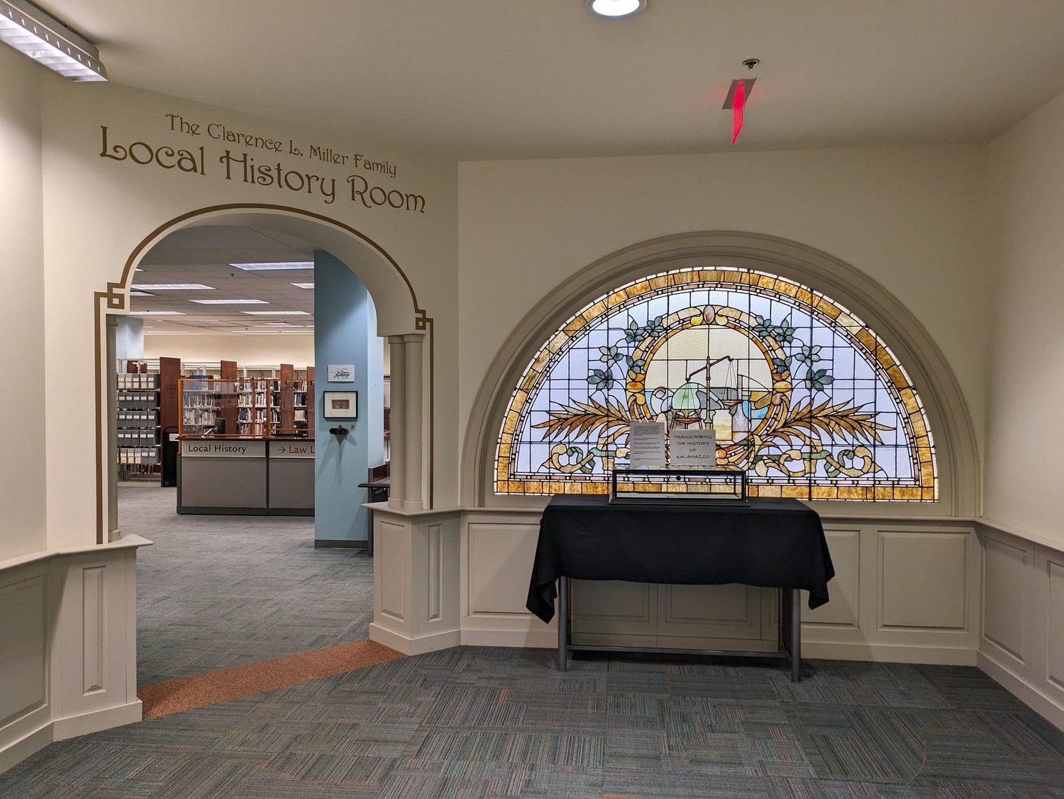 Entrance to the Local History Room next to a stained glass backlit window