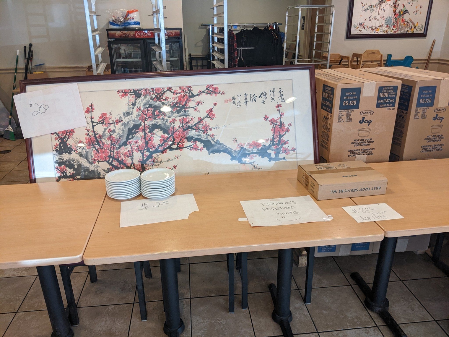 A cherry blossom tree, plates, and a pack of zodiac placemats for sale