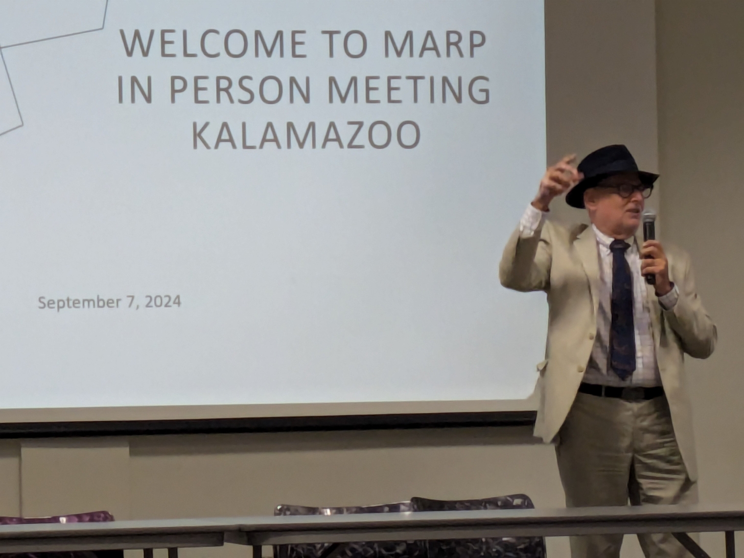 Buckley in front of the projector, gesturing animatedly to the crowd