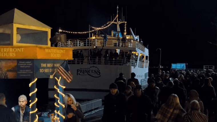 A yacht with the Detroit Princess logo docked next to a ticketbooth