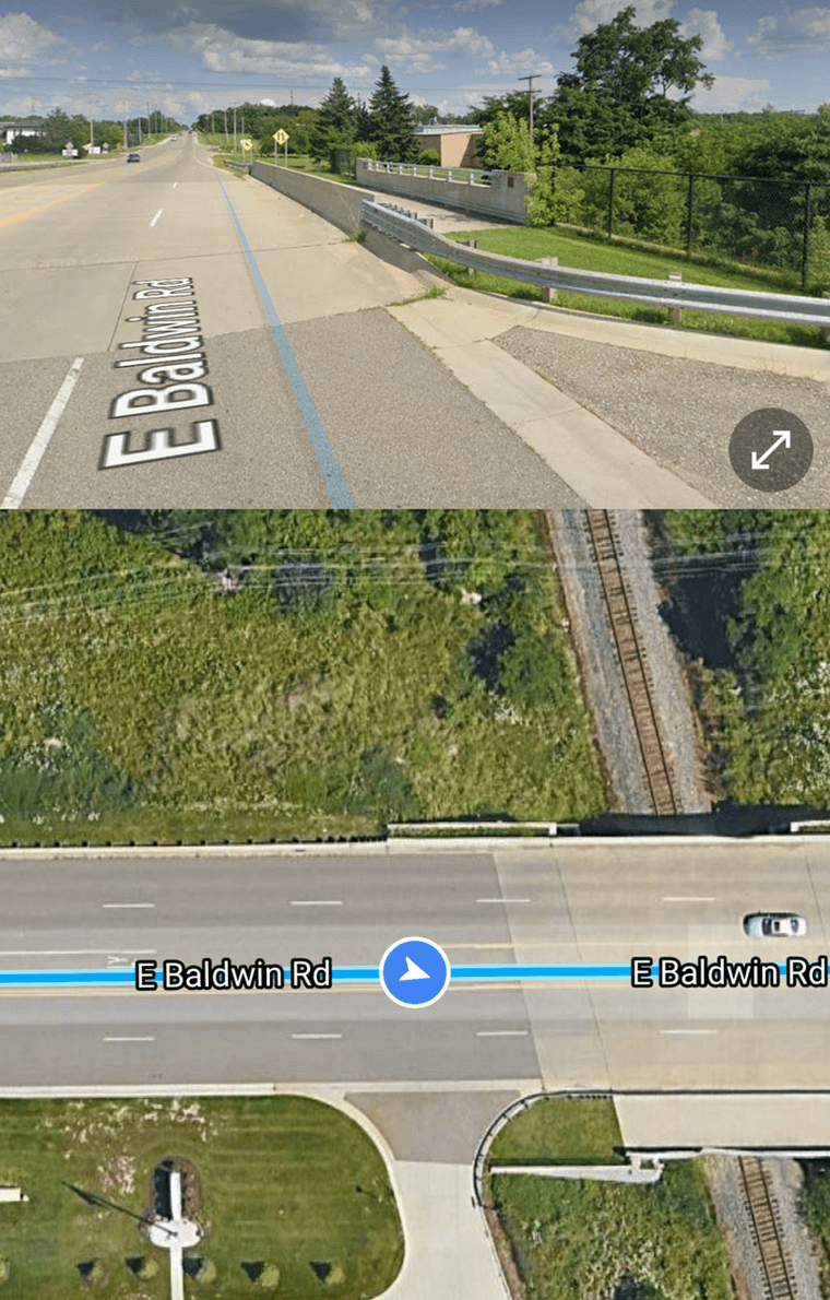 A Google Street View screenshot of a bridge over train tracks along Baldwin Road constructed with a sidewalk stub.