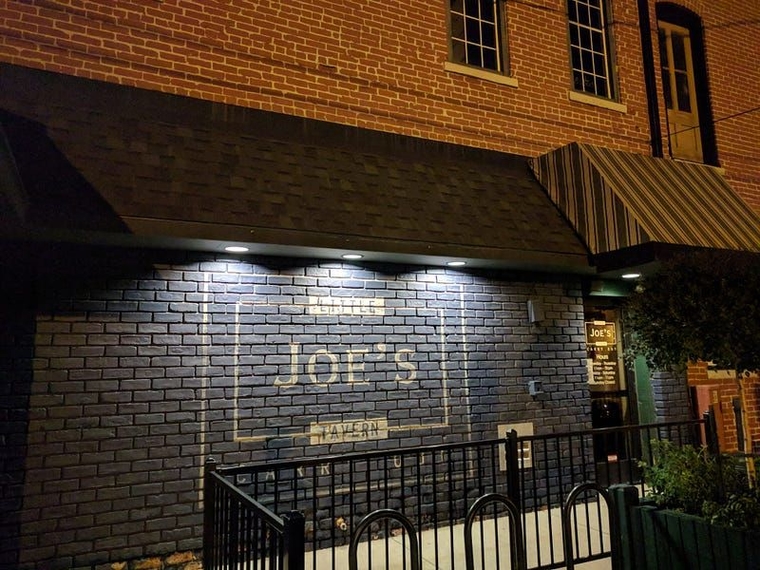 Blue brick building with a bike rack in front