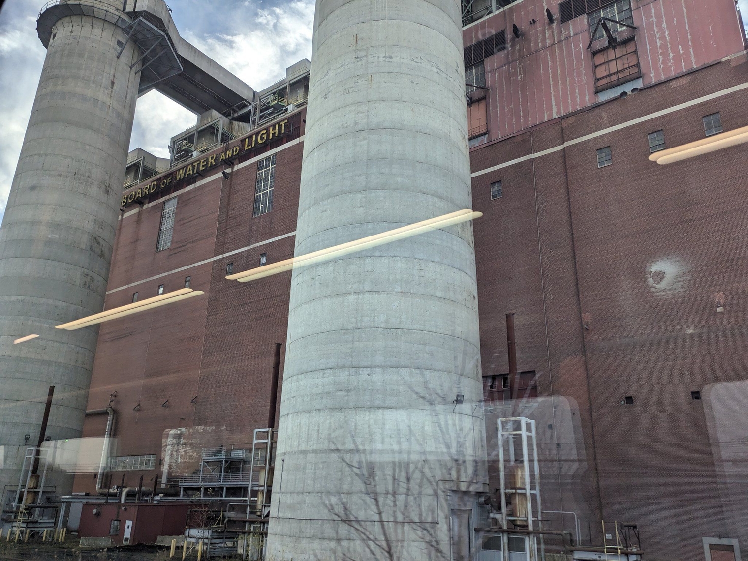 The base of the three stacks of the power plant, known to locals as Wynken, Blynken, and Nod. The "Lansing Board of Water and Light" inscription atop the power plant is visible