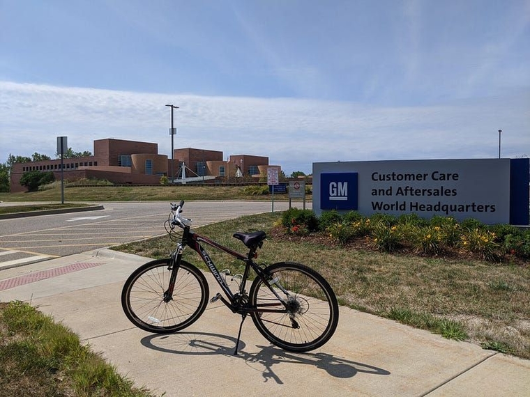 alt="My bike in front of the sign for General Motors Customer Care and Aftersales World Headquarters."