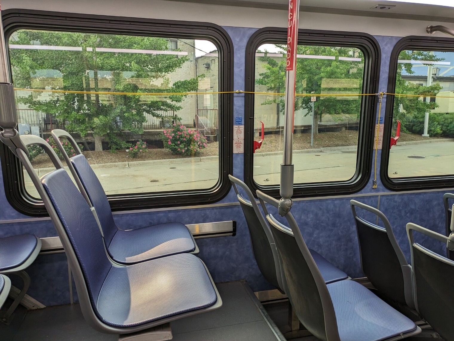 Bus interior with blue paneling and blue seats