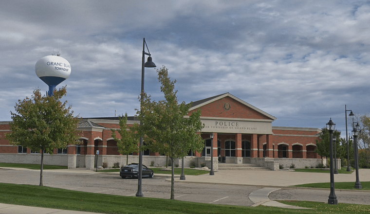 The new Grand Blanc Township Police Station on Saginaw, with the white and blue township water tower behind it.