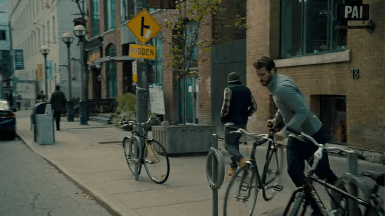 Dodge stealing a bike parked along the street