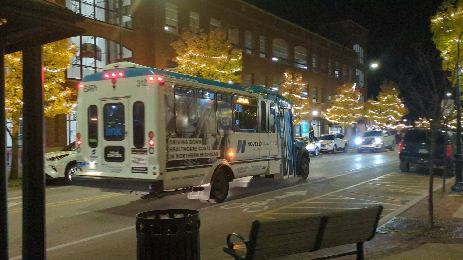 BATA Bay Line minibus, a blue and white cutaway, departing the stop