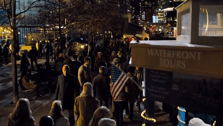 A large crowd walking along the Toronto waterfront