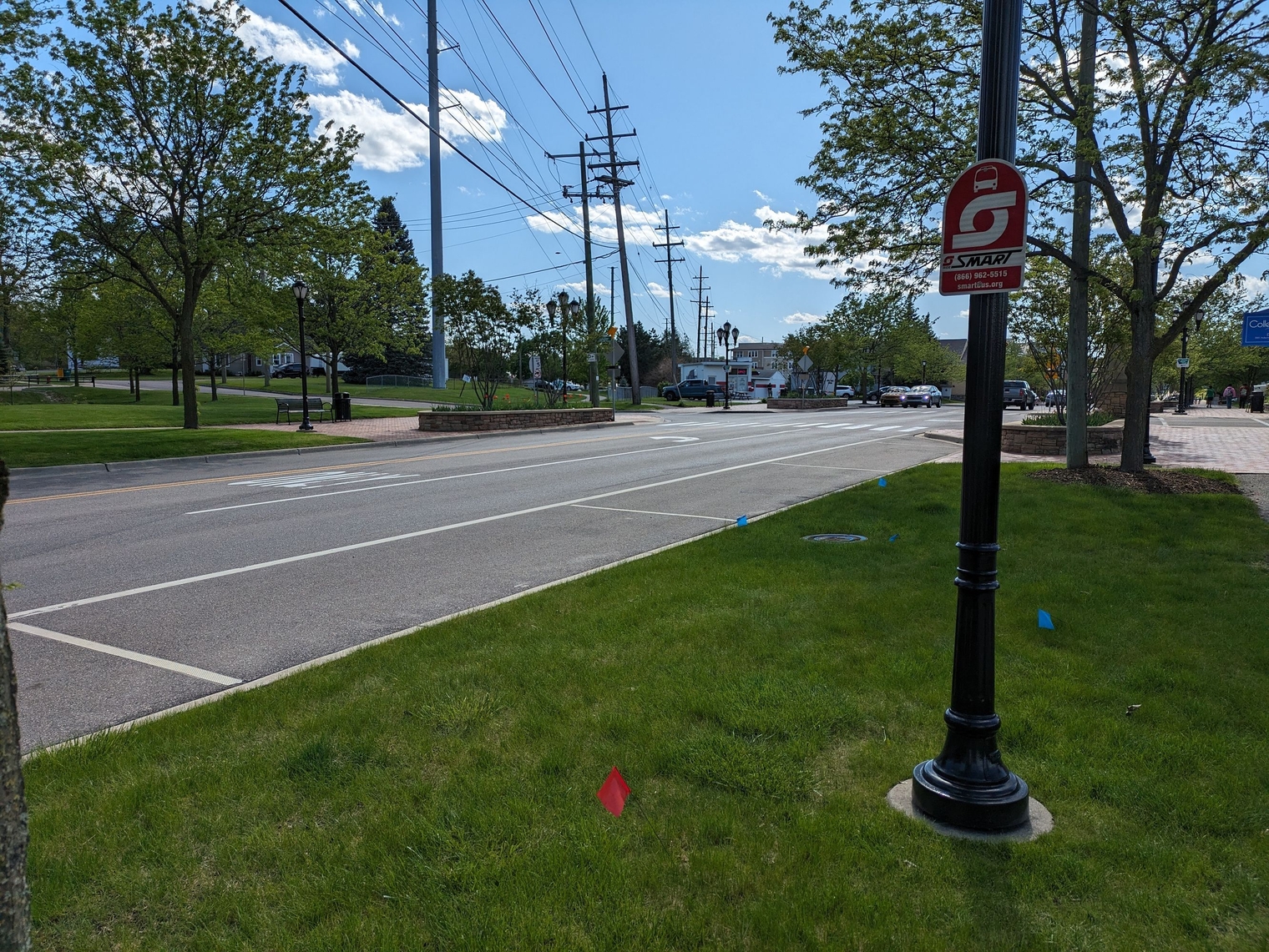 Bus stop blocked by street parking and with no concrete pad