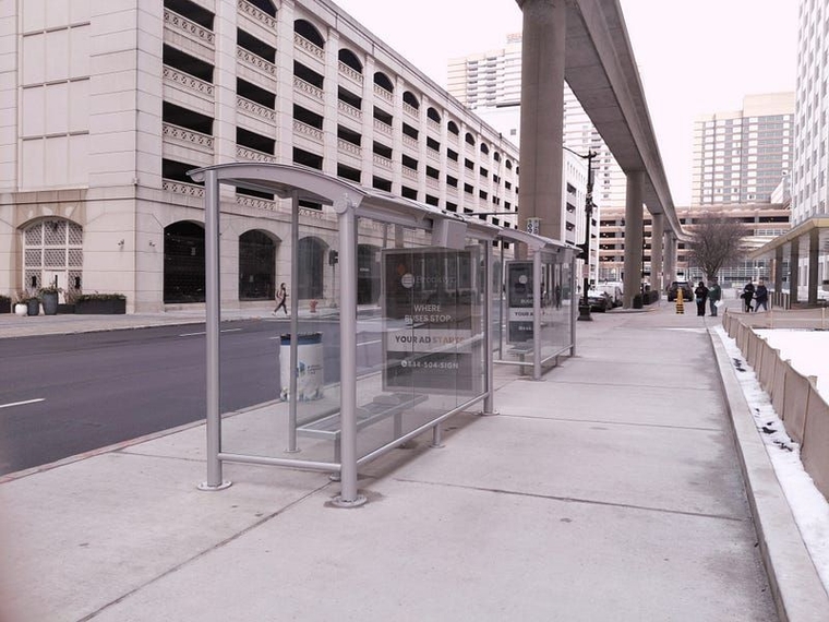 Two glass shelters along Larned underneath the People Mover track.