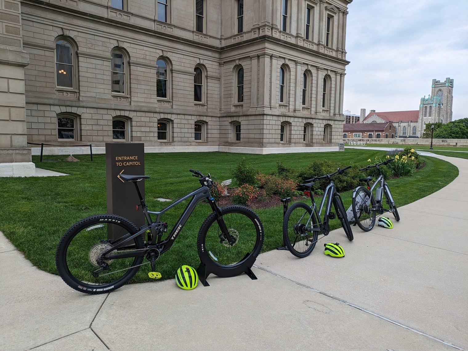 Three Trek e-bikes with helmets outside the Capitol