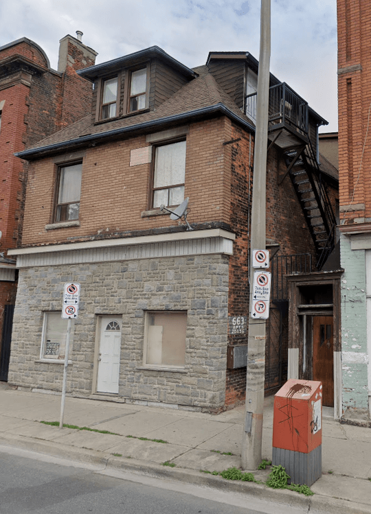 A brick house and a fire escape in the alleyway