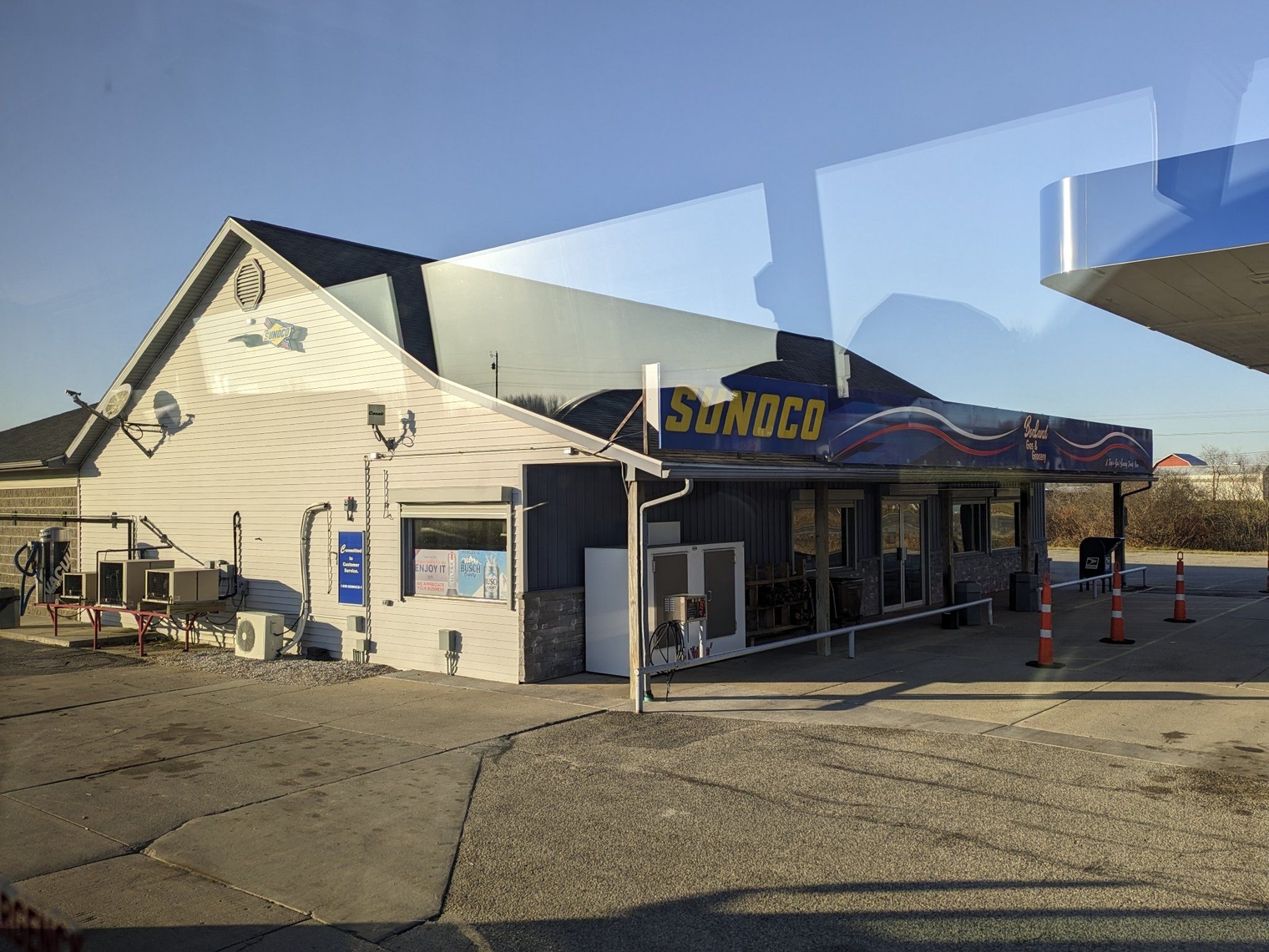 Small convenience store next to a Sunoco gas station