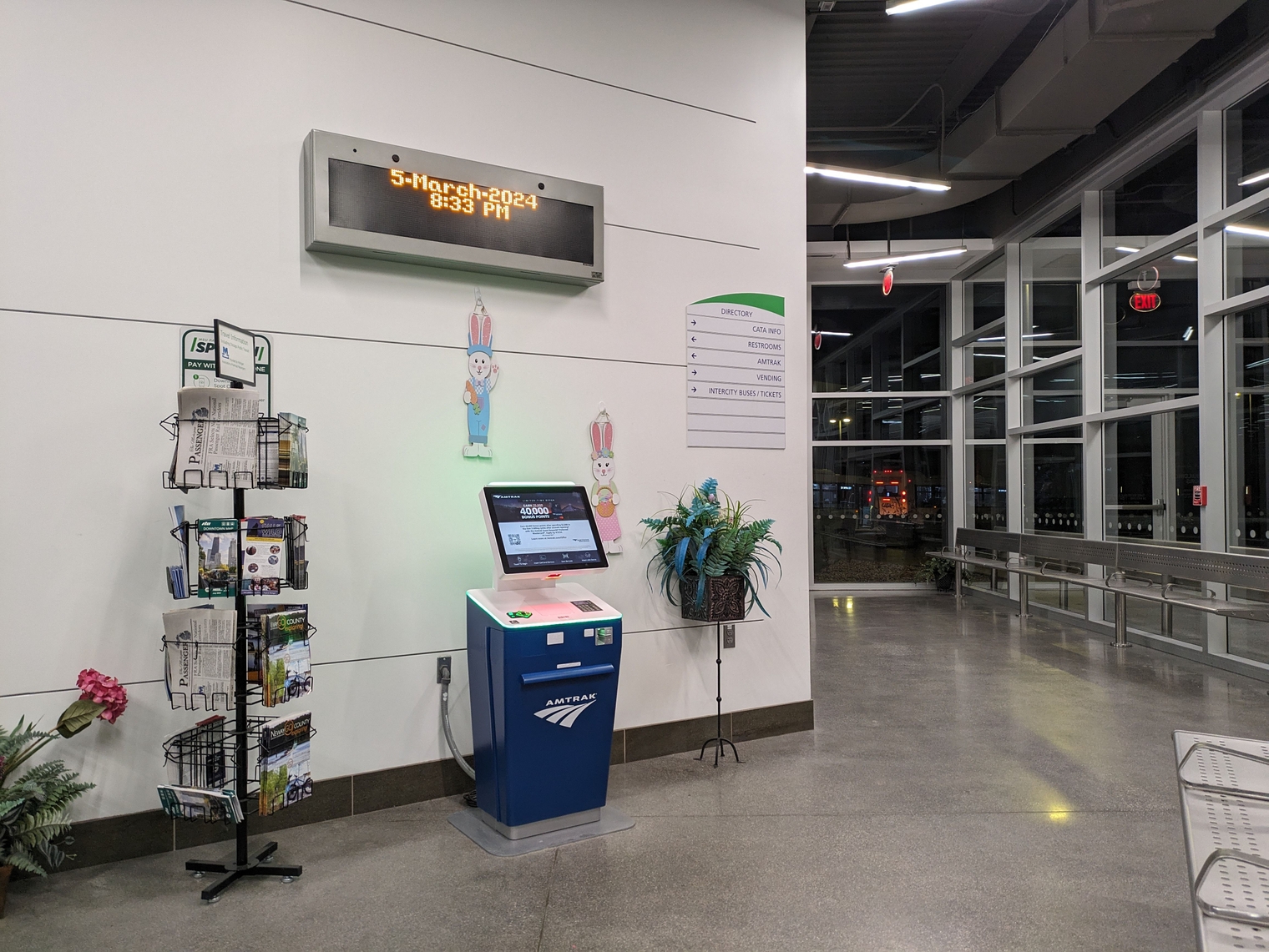 The automated ticketing kiosk inside the Multimodal Gateway, next to a rack of brochures and maps including MARP's magazine, The Michigan Passenger