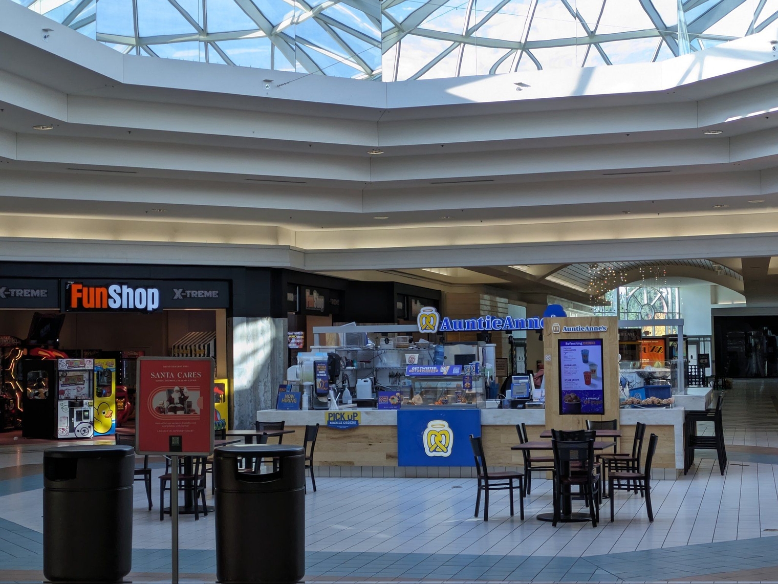 The pretzel stand in the middle of the mall under a skylight