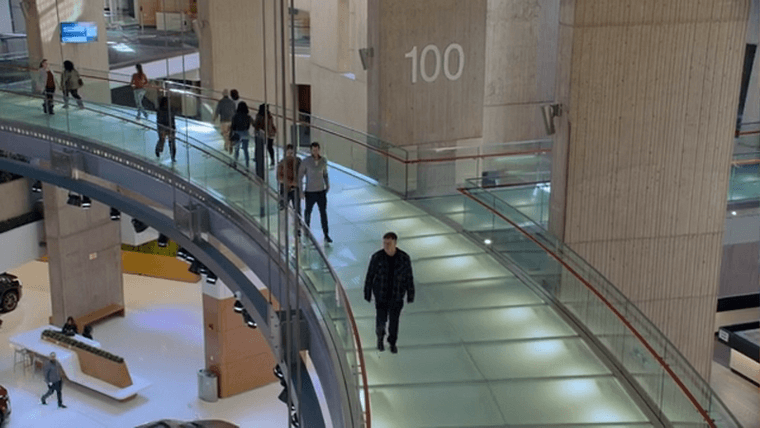 A suspended walkway with translucent glass flooring