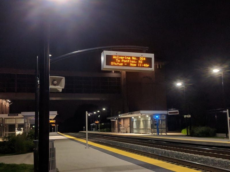 The departure display above the tracks in Dearborn. It reads "Wolverine Number 354 to Pontiac, MI: Status, Now 11:48pm"