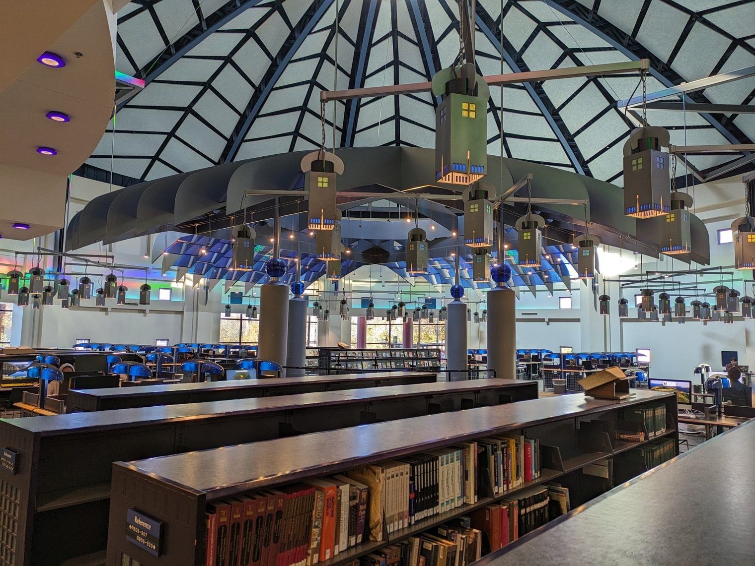 Second floor computer room with a large dome skylight and blue lamps hanging from the ceiling