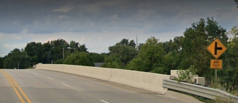 A screenshot of Google Street View showing the Fenton Road bridge over I-75. A concrete barrier comes up directly against the outer travel lane.