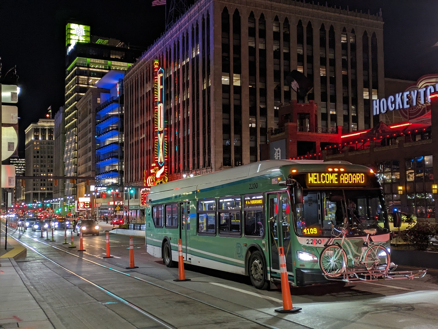 A DDOT bus traveling north along Woodward past the Fox Theater, across from Comerica Park, in heavy event traffic at night