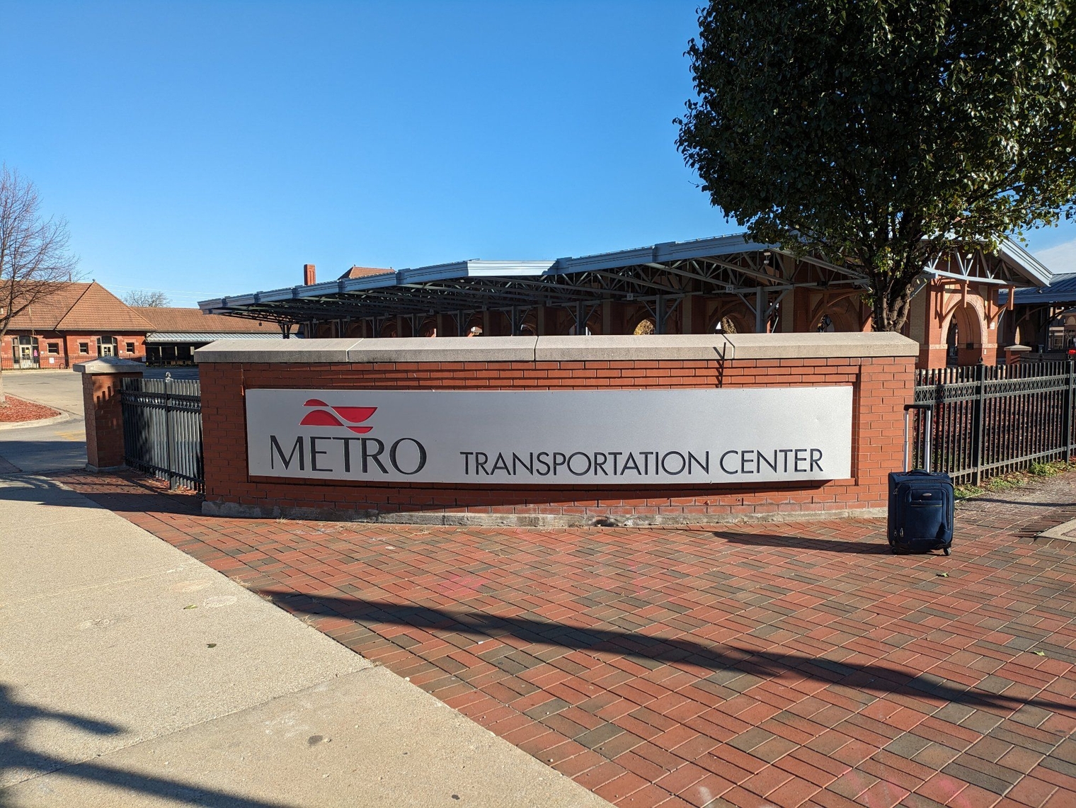 My suitcase next to the Metro Transportation Center sign