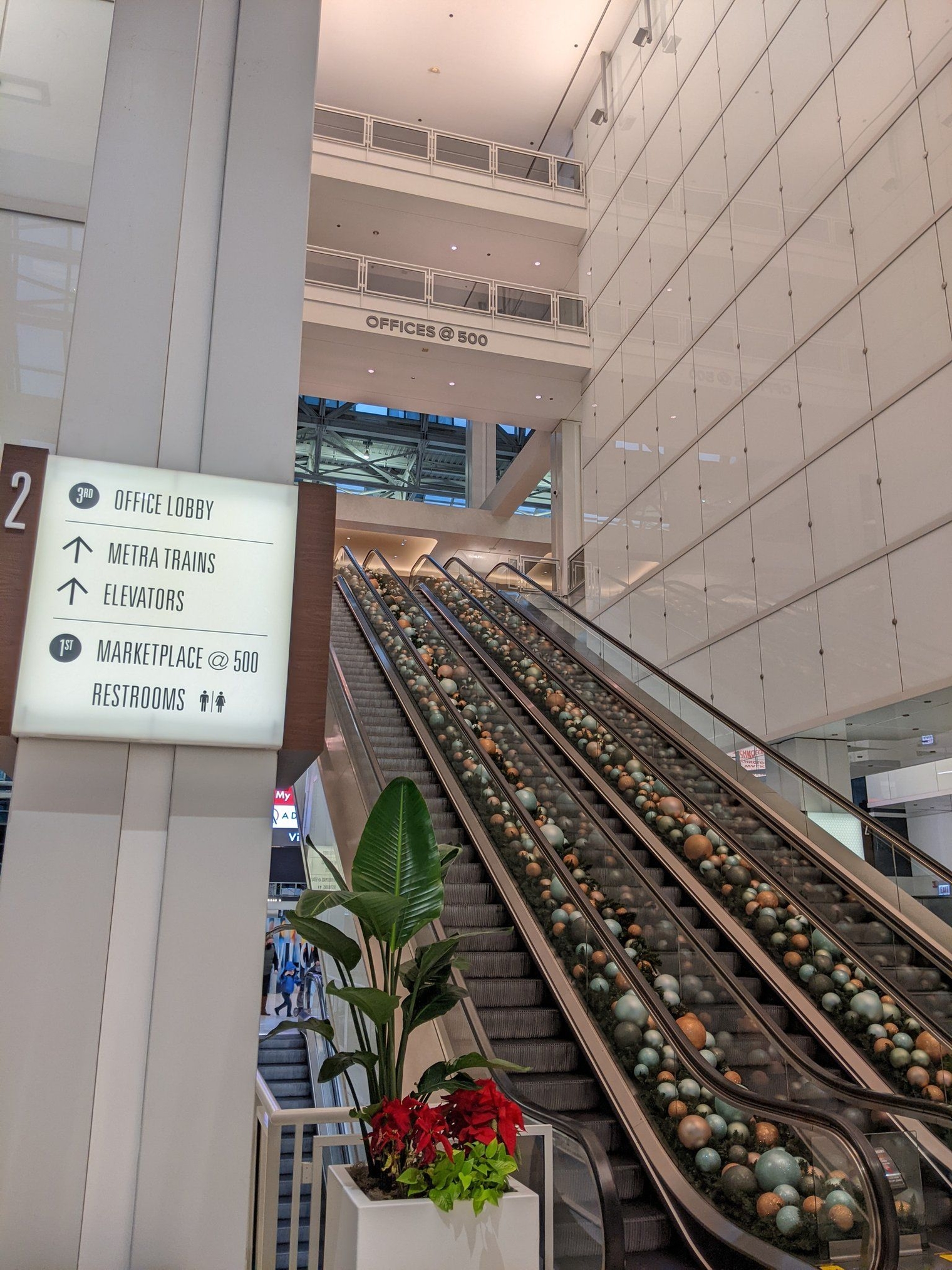 Decorative rocks in between escalators next to a large navigational sign