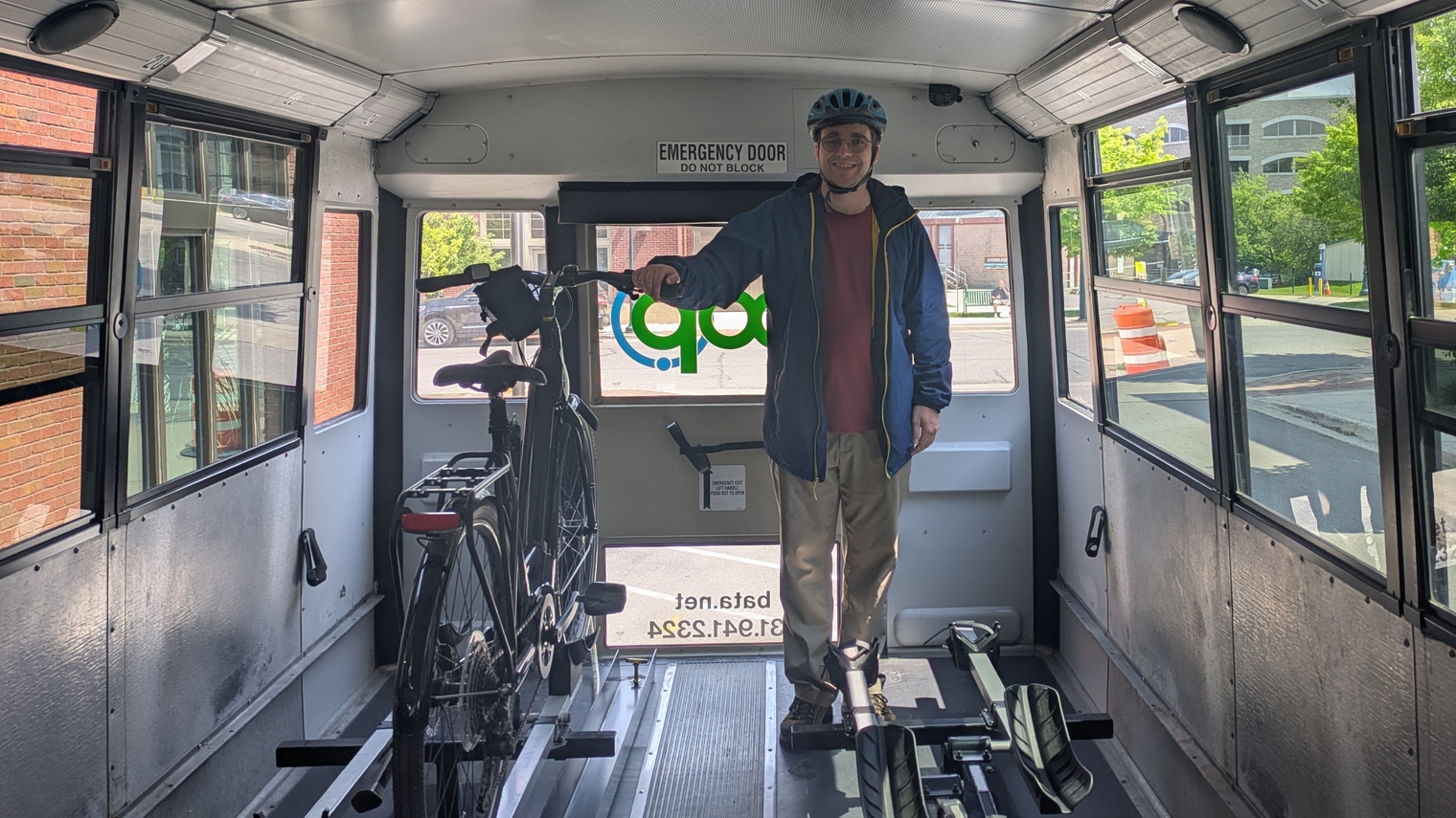 Me standing next to my bike onboard a BATA bus with interior racks