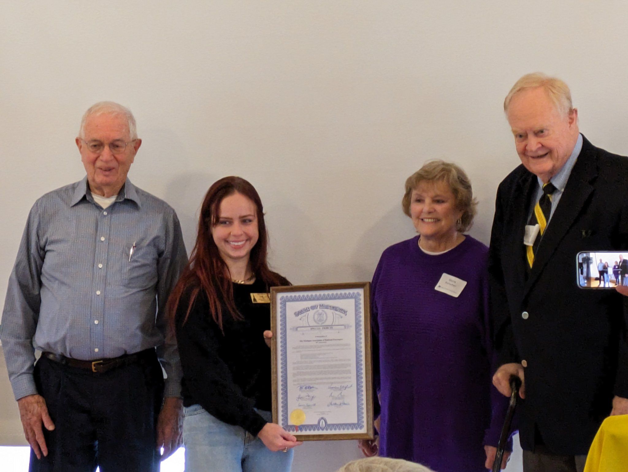 Em holding the framed tribute for a photo with members of the MARP Board of Directors
