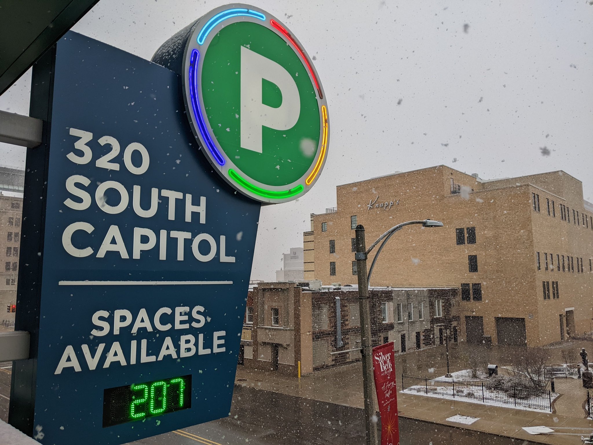 Sign for South Capitol Parking in Lansing during a snowstorm